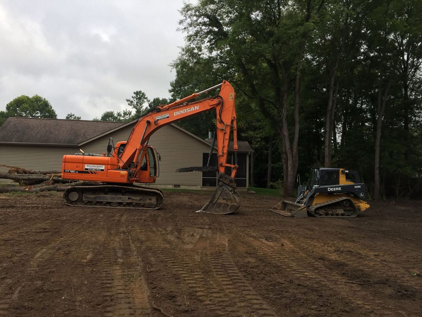 Walker Precision Excavating equipment parked on a job site