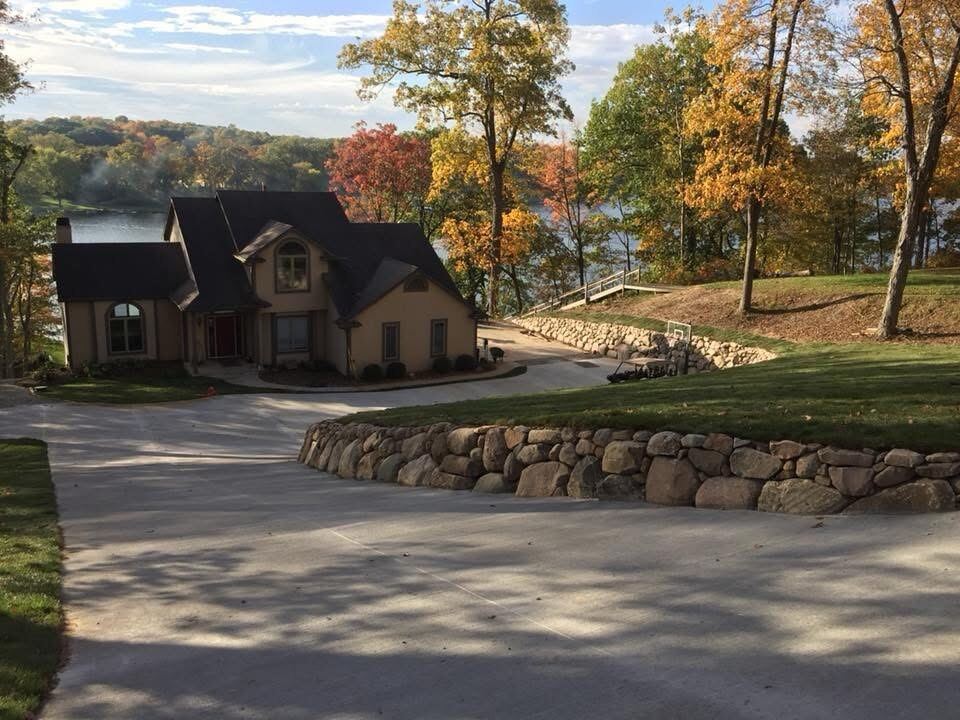 Finished pond-area grading and stonework on a lakefront property